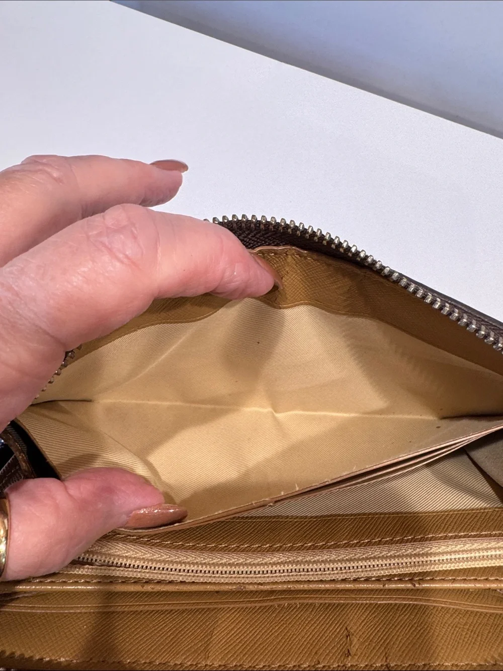 Coach Brown/Tan Signature Zip Wallet with Logo Plaque tags inside.